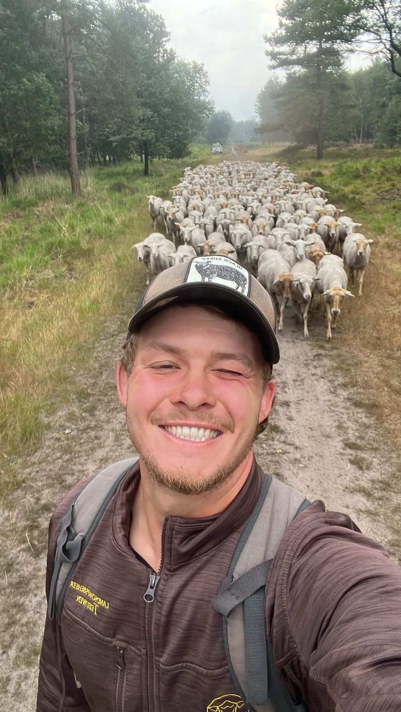 Luc Teeuwen maakt een selfie met de kudde achter zich